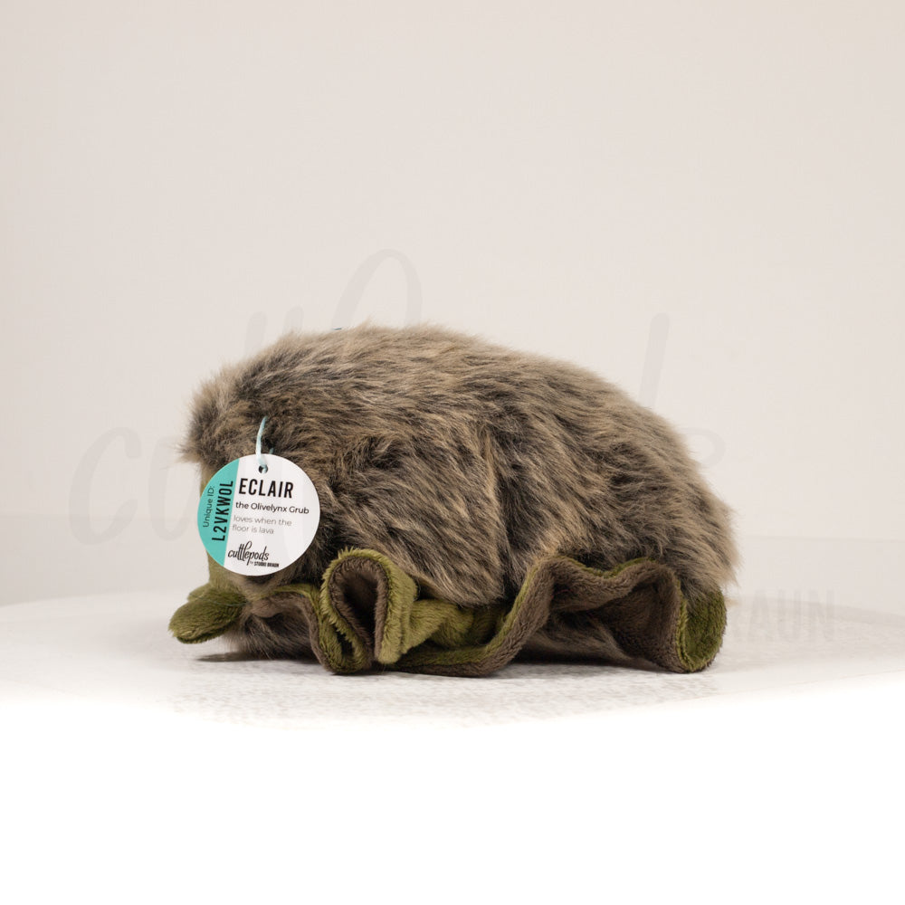 Side profile view of a cuttlepod plush toy, showcasing two-tone ruffled fins, and a cuddly, furry body.