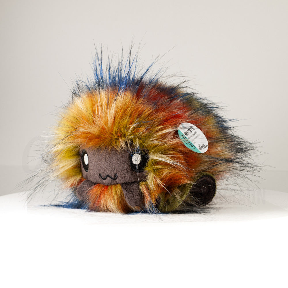 Front view of a cuttlepod plush toy, captured at a slight angle to highlight its charming features: large, cartoonish eyes, ruffled fins, and a cuddly, furry texture.