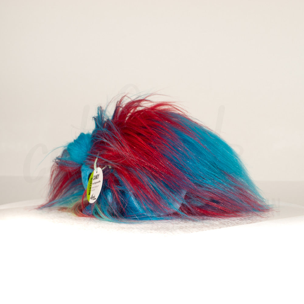 Side profile view of a cuttlepod plush toy, showcasing two-tone ruffled fins, and a cuddly, furry body.