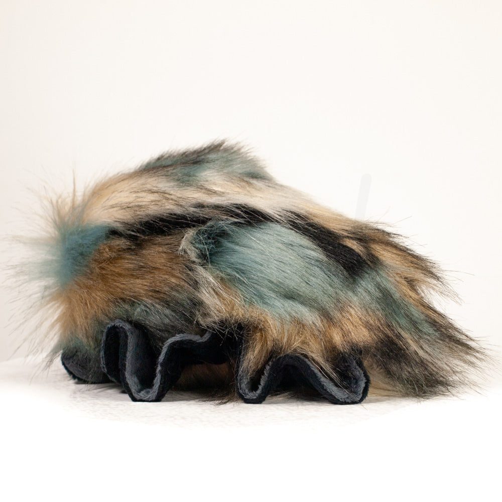 Slightly angled back view of a cuttlepod plush toy, highlighting two-tone ruffled fins, and a cuddly, furry body that comes to a soft point at the rear.