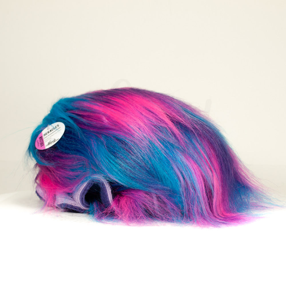 Slightly angled back view of a cuttlepod plush toy, highlighting two-tone ruffled fins, and a cuddly, furry body that comes to a soft point at the rear.