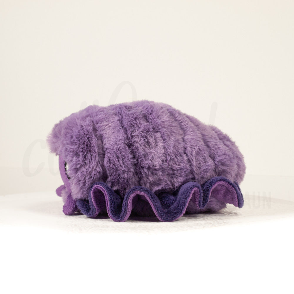 Side profile view of a cuttlepod plush toy, showcasing two-tone ruffled fins, and a cuddly, furry body.