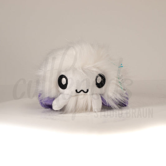 Front view of a cuttlepod plush toy, showcasing its unique form with large, cartoonish eyes, ruffled fins, and a cuddly, furry texture.