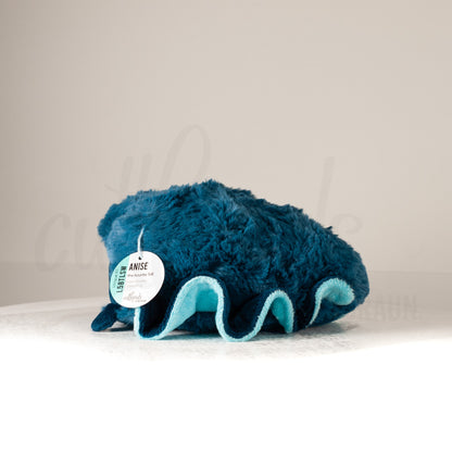 Side profile view of a cuttlepod plush toy, showcasing two-tone ruffled fins, and a cuddly, furry body.