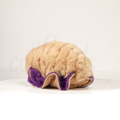 Slightly angled back view of a cuttlepod plush toy, highlighting two-tone ruffled fins, and a cuddly, furry body that comes to a soft point at the rear.