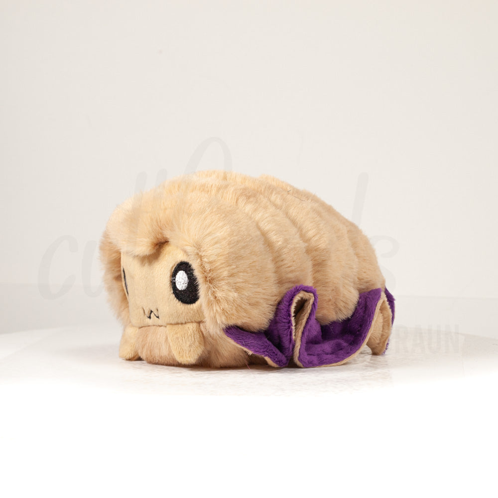 Front view of a cuttlepod plush toy, captured at a slight angle to highlight its charming features: large, cartoonish eyes, ruffled fins, and a cuddly, furry texture.