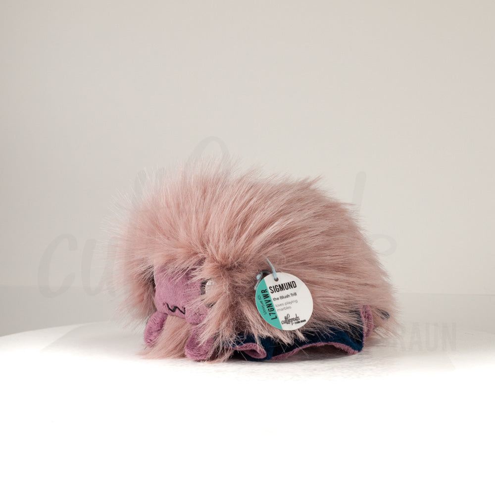 Front view of a cuttlepod plush toy, captured at a slight angle to highlight its charming features: large, cartoonish eyes, ruffled fins, and a cuddly, furry texture.