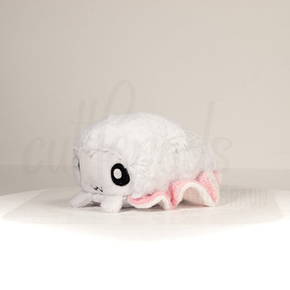 Front view of a cuttlepod plush toy, captured at a slight angle to highlight its charming features: large, cartoonish eyes, ruffled fins, and a cuddly, furry texture.