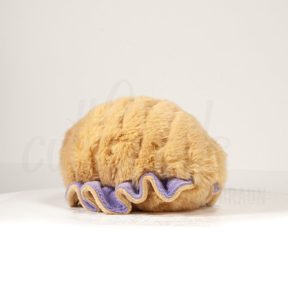 Slightly angled back view of a cuttlepod plush toy, highlighting two-tone ruffled fins, and a cuddly, furry body that comes to a soft point at the rear.