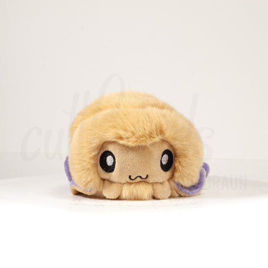 Front view of a cuttlepod plush toy, showcasing its unique form with large, cartoonish eyes, ruffled fins, and a cuddly, furry texture.