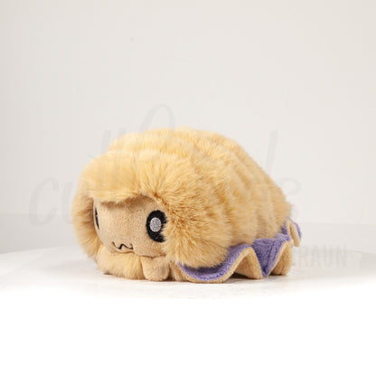 Front view of a cuttlepod plush toy, captured at a slight angle to highlight its charming features: large, cartoonish eyes, ruffled fins, and a cuddly, furry texture.