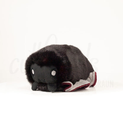 Front view of a cuttlepod plush toy, captured at a slight angle to highlight its charming features: large, cartoonish eyes, ruffled fins, and a cuddly, furry texture.