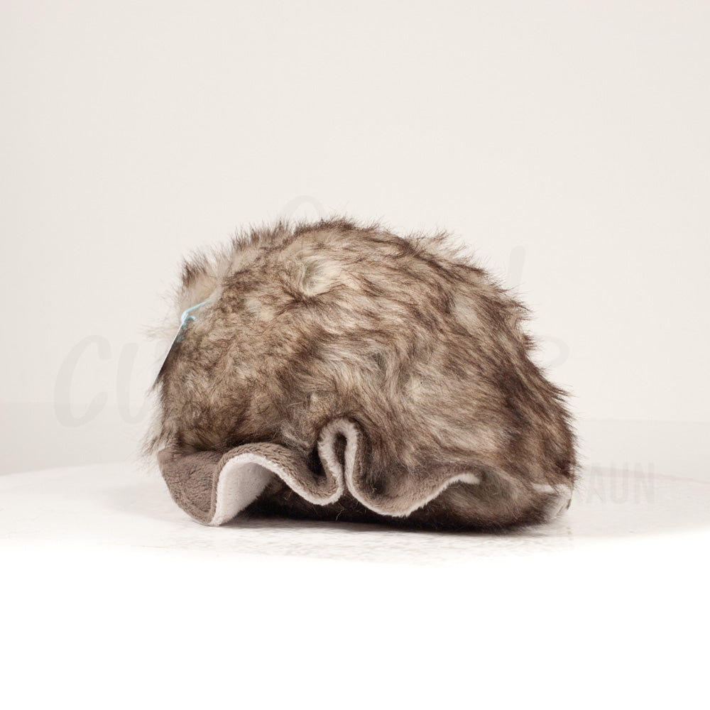 Slightly angled back view of a cuttlepod plush toy, highlighting two-tone ruffled fins, and a cuddly, furry body that comes to a soft point at the rear.