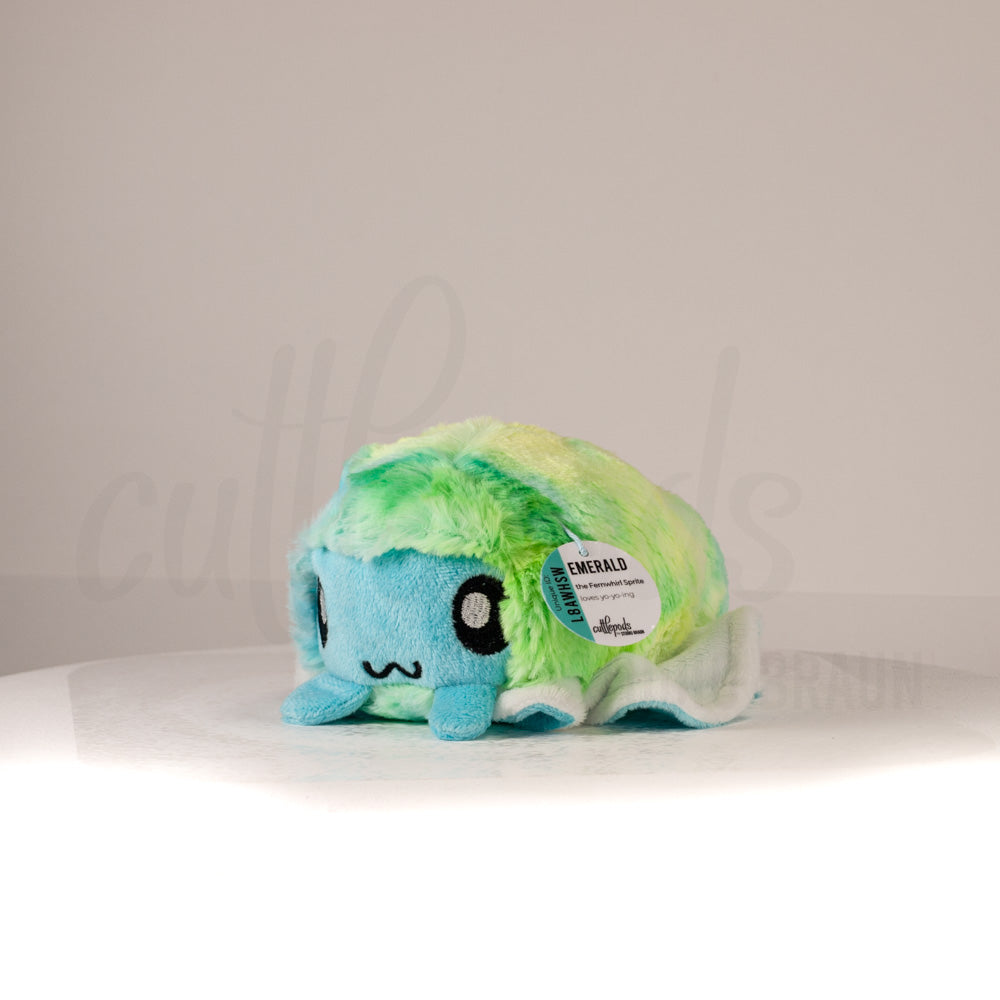 Front view of a cuttlepod plush toy, captured at a slight angle to highlight its charming features: large, cartoonish eyes, ruffled fins, and a cuddly, furry texture.