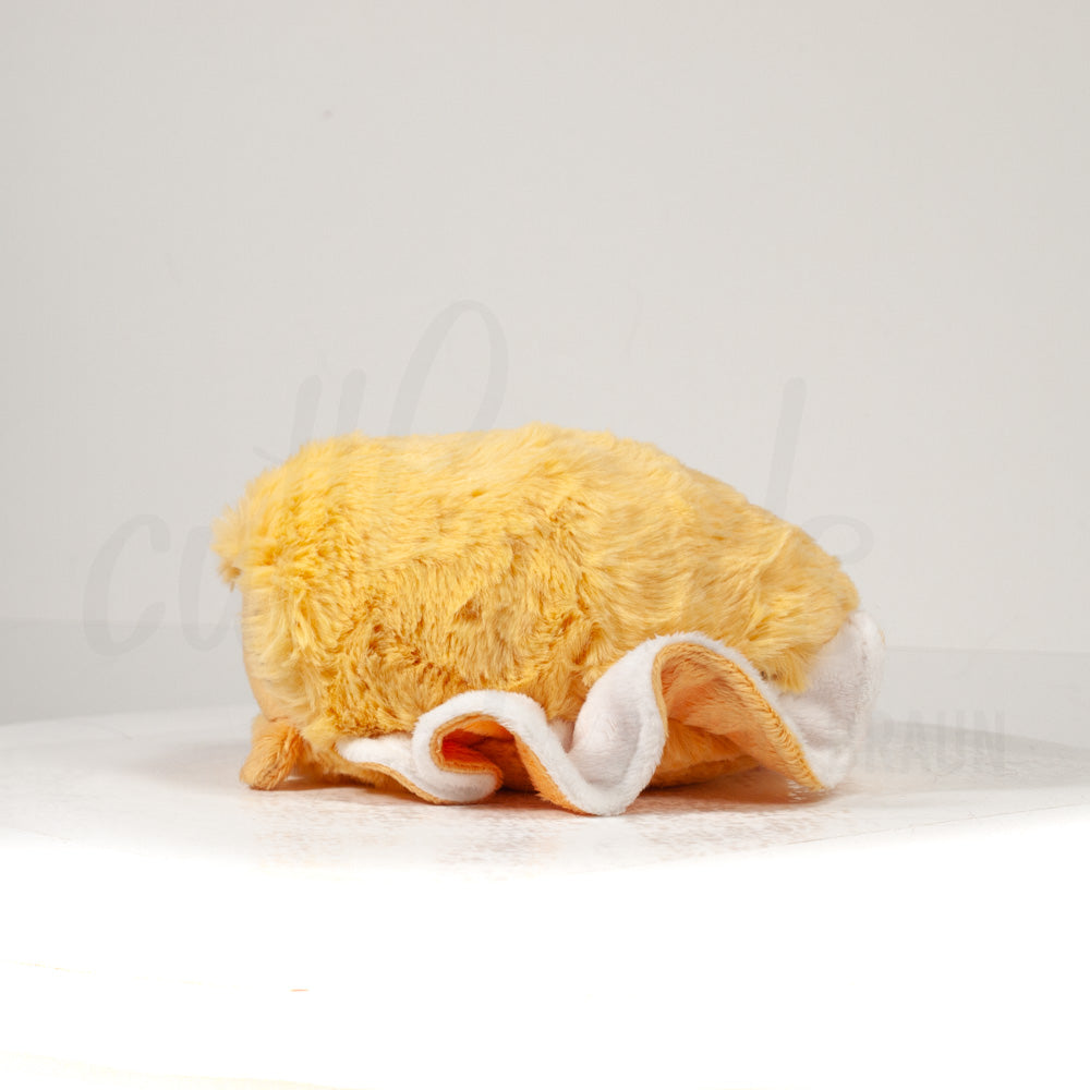 Side profile view of a cuttlepod plush toy, showcasing two-tone ruffled fins, and a cuddly, furry body.