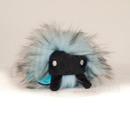 Front view of a cuttlepod plush toy, showcasing its unique form with large, cartoonish eyes, ruffled fins, and a cuddly, furry texture.