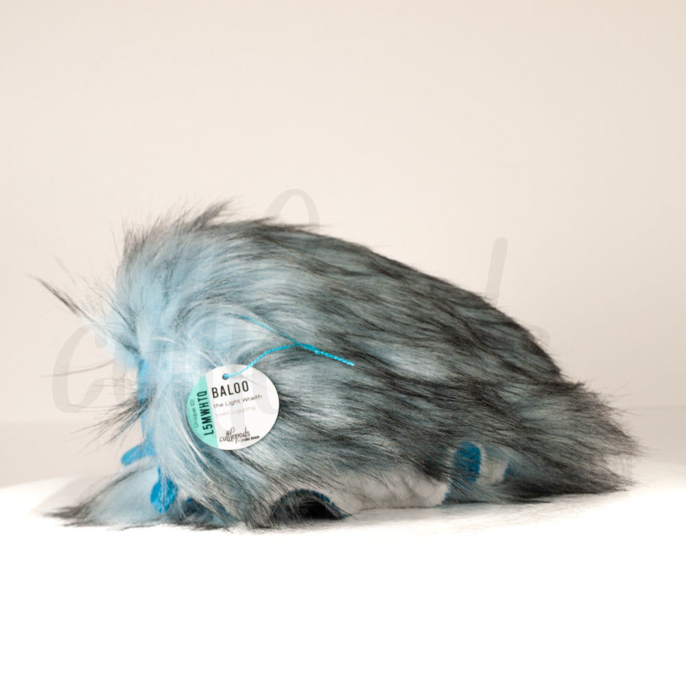 Side profile view of a cuttlepod plush toy, showcasing two-tone ruffled fins, and a cuddly, furry body.