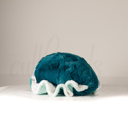 Slightly angled back view of a cuttlepod plush toy, highlighting two-tone ruffled fins, and a cuddly, furry body that comes to a soft point at the rear.