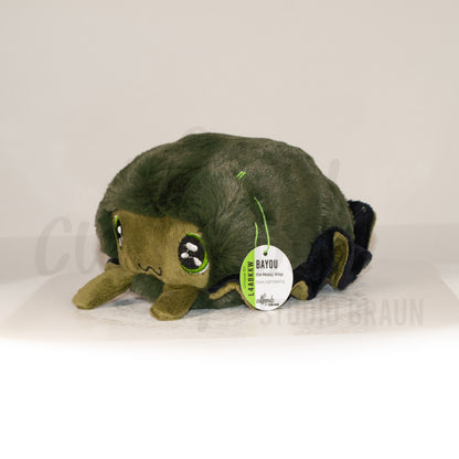 Front view of a cuttlepod plush toy, captured at a slight angle to highlight its charming features: large, cartoonish eyes, ruffled fins, and a cuddly, furry texture.