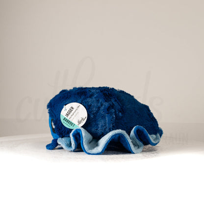 Side profile view of a cuttlepod plush toy, showcasing two-tone ruffled fins, and a cuddly, furry body.