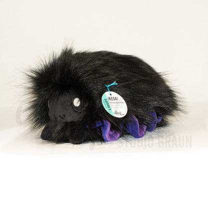 Front view of a cuttlepod plush toy, captured at a slight angle to highlight its charming features: large, cartoonish eyes, ruffled fins, and a cuddly, furry texture.