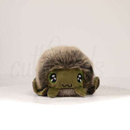 Front view of a cuttlepod plush toy, showcasing its unique form with large, cartoonish eyes, ruffled fins, and a cuddly, furry texture.