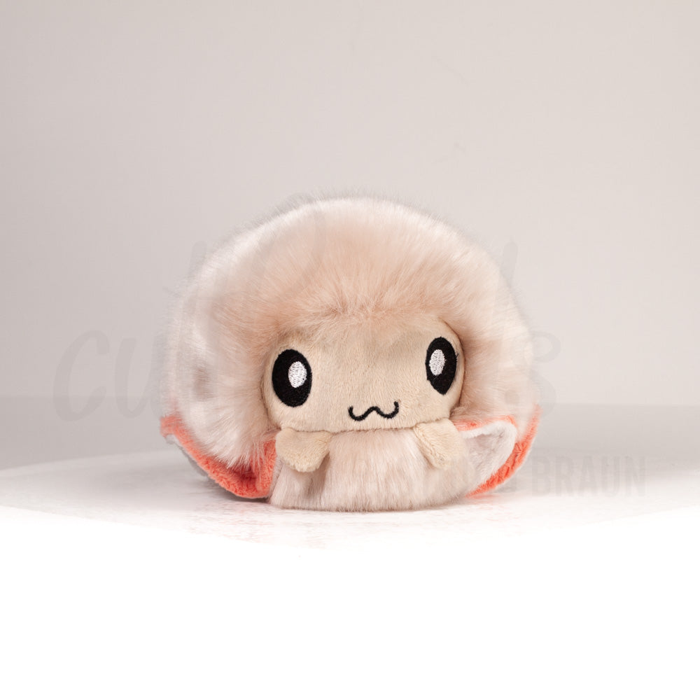 Front view of a cuttlepod plush toy, showcasing its unique form with large, cartoonish eyes, ruffled fins, and a cuddly, furry texture.