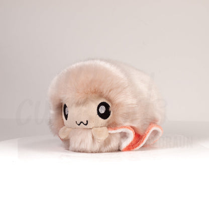 Front view of a cuttlepod plush toy, captured at a slight angle to highlight its charming features: large, cartoonish eyes, ruffled fins, and a cuddly, furry texture.