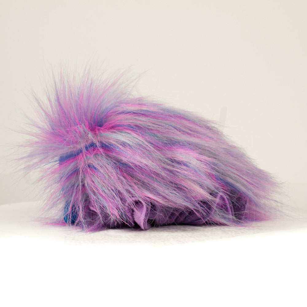 Side profile view of a cuttlepod plush toy, showcasing two-tone ruffled fins, and a cuddly, furry body.