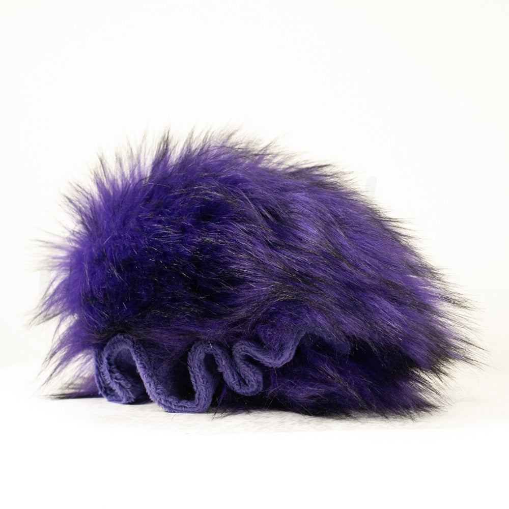 Slightly angled back view of a cuttlepod plush toy, highlighting two-tone ruffled fins, and a cuddly, furry body that comes to a soft point at the rear.