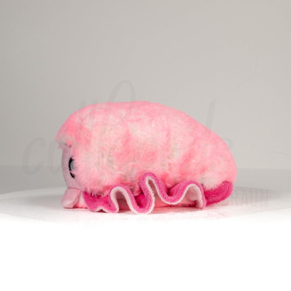 Side profile view of a cuttlepod plush toy, showcasing two-tone ruffled fins, and a cuddly, furry body.