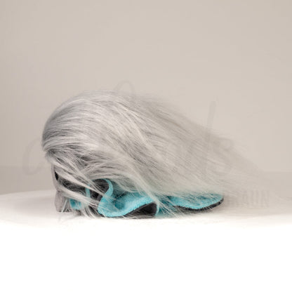 Side profile view of a cuttlepod plush toy, showcasing two-tone ruffled fins, and a cuddly, furry body.