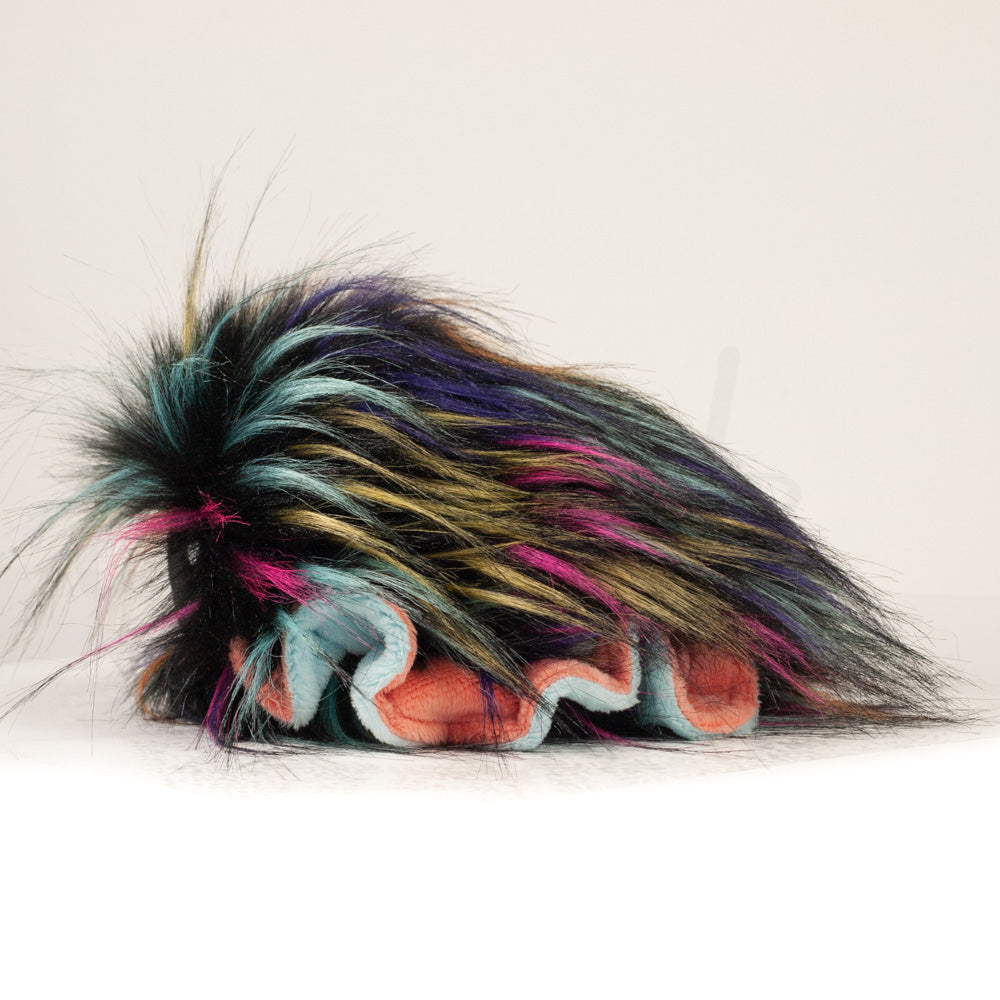 Side profile view of a cuttlepod plush toy, showcasing two-tone ruffled fins, and a cuddly, furry body.