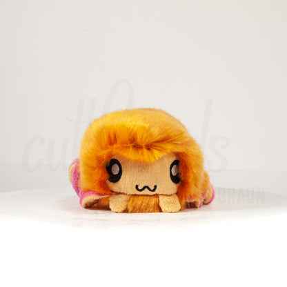 Front view of a cuttlepod plush toy, showcasing its unique form with large, cartoonish eyes, ruffled fins, and a cuddly, furry texture.