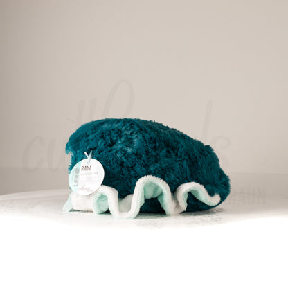 Side profile view of a cuttlepod plush toy, showcasing two-tone ruffled fins, and a cuddly, furry body.