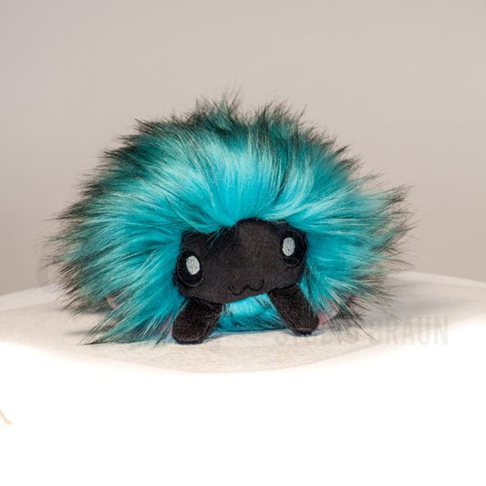 Front view of a cuttlepod plush toy, showcasing its unique form with large, cartoonish eyes, ruffled fins, and a cuddly, furry texture.