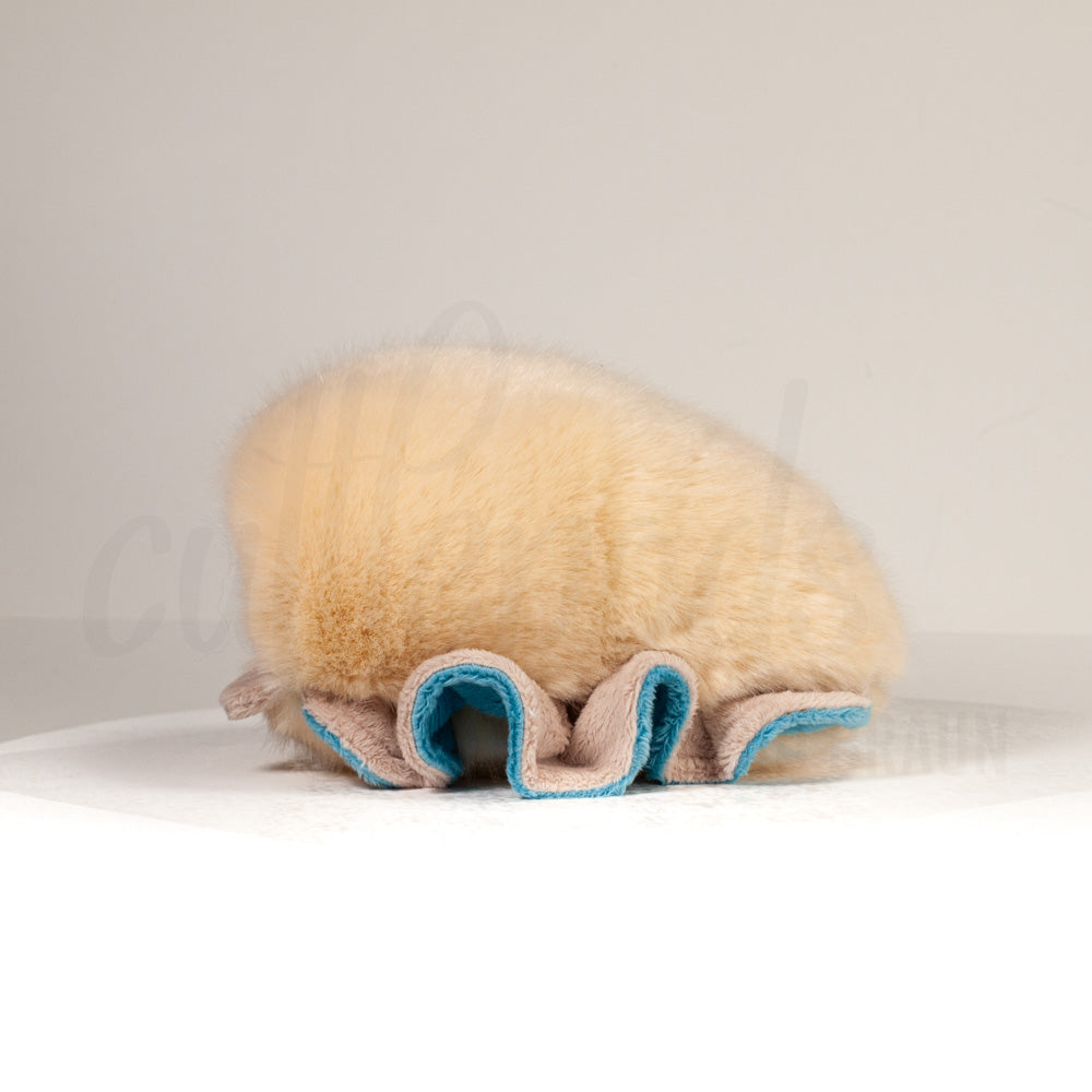 Side profile view of a cuttlepod plush toy, showcasing two-tone ruffled fins, and a cuddly, furry body.