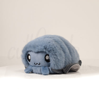 Front view of a cuttlepod plush toy, captured at a slight angle to highlight its charming features: large, cartoonish eyes, ruffled fins, and a cuddly, furry texture.