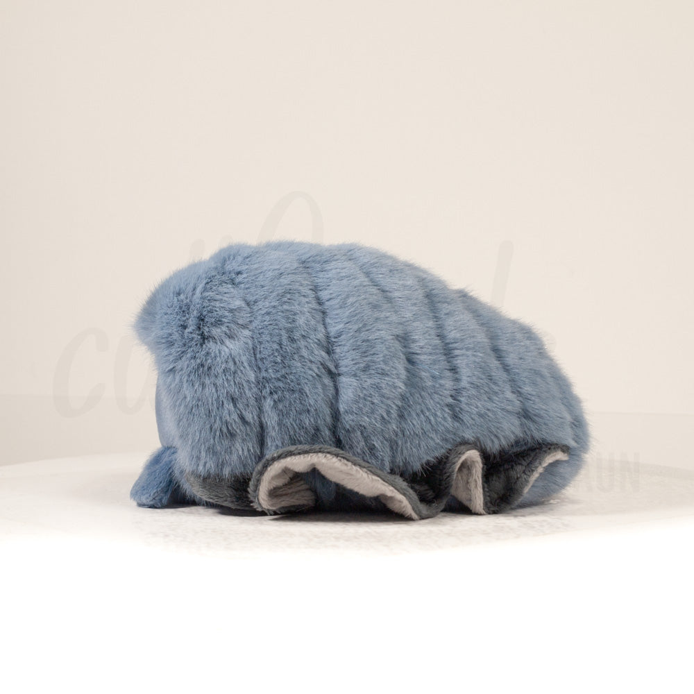 Side profile view of a cuttlepod plush toy, showcasing two-tone ruffled fins, and a cuddly, furry body.