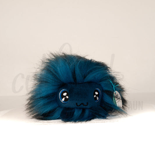 Front view of a cuttlepod plush toy, showcasing its unique form with large, cartoonish eyes, ruffled fins, and a cuddly, furry texture.