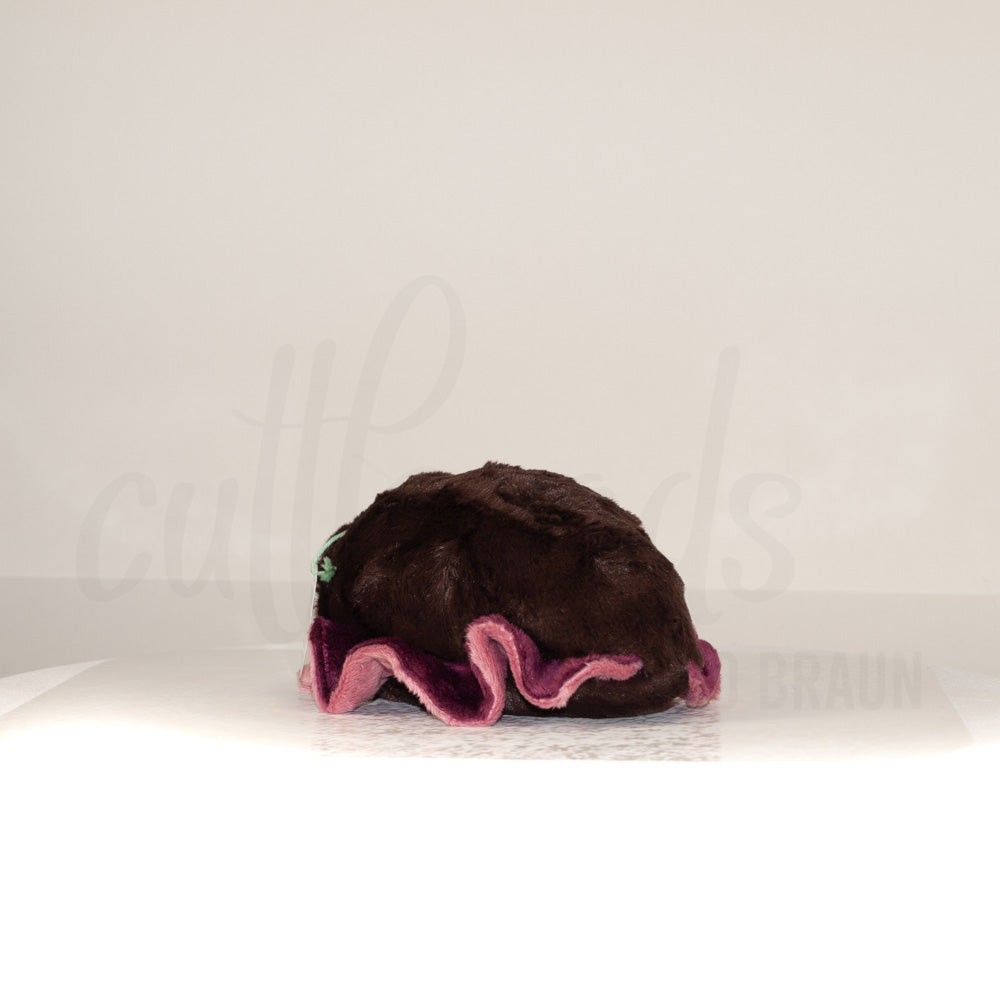 Slightly angled back view of a cuttlepod plush toy, highlighting two-tone ruffled fins, and a cuddly, furry body that comes to a soft point at the rear.