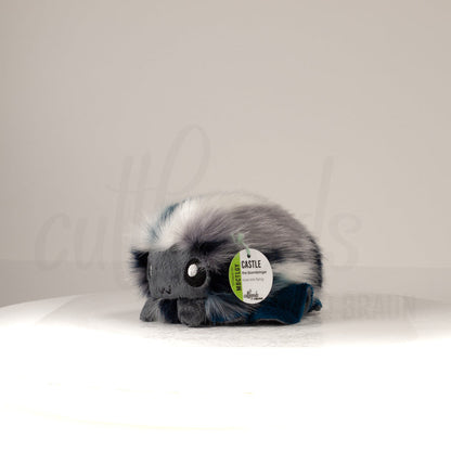 Front view of a cuttlepod plush toy, captured at a slight angle to highlight its charming features: large, cartoonish eyes, ruffled fins, and a cuddly, furry texture.