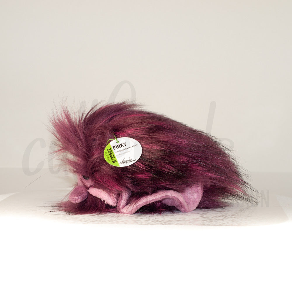 Side profile view of a cuttlepod plush toy, showcasing two-tone ruffled fins, and a cuddly, furry body.