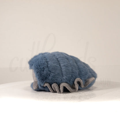 Side profile view of a cuttlepod plush toy, showcasing two-tone ruffled fins, and a cuddly, furry body.