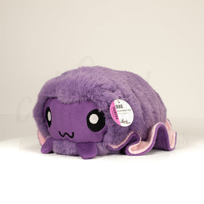 Front view of a cuttlepod plush toy, captured at a slight angle to highlight its charming features: large, cartoonish eyes, ruffled fins, and a cuddly, furry texture.