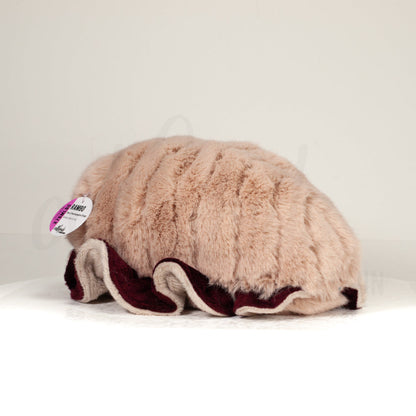 Slightly angled back view of a cuttlepod plush toy, highlighting two-tone ruffled fins, and a cuddly, furry body that comes to a soft point at the rear.