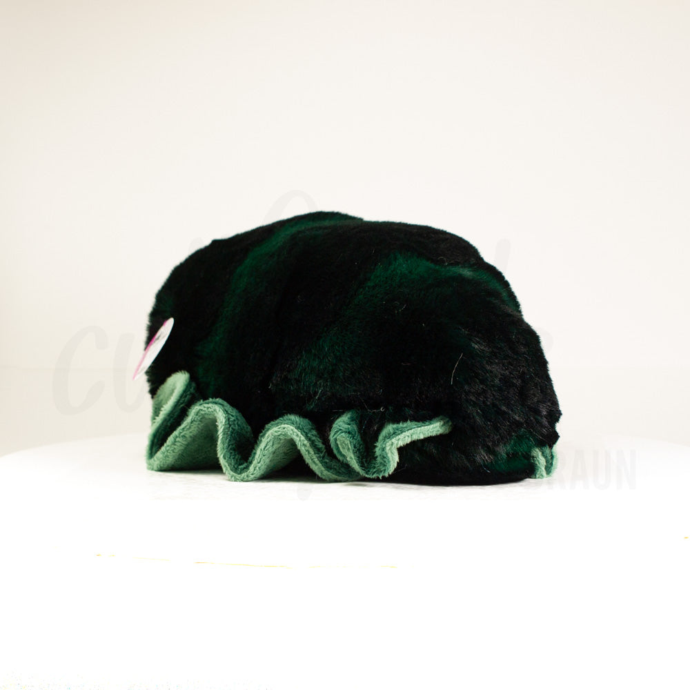 Slightly angled back view of a cuttlepod plush toy, highlighting two-tone ruffled fins, and a cuddly, furry body that comes to a soft point at the rear.