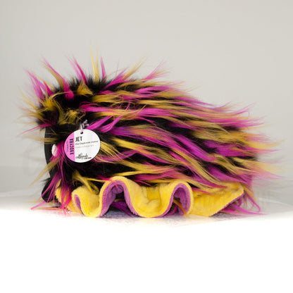 Side profile view of a cuttlepod plush toy, showcasing two-tone ruffled fins, and a cuddly, furry body.