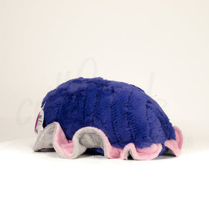 Slightly angled back view of a cuttlepod plush toy, highlighting two-tone ruffled fins, and a cuddly, furry body that comes to a soft point at the rear.