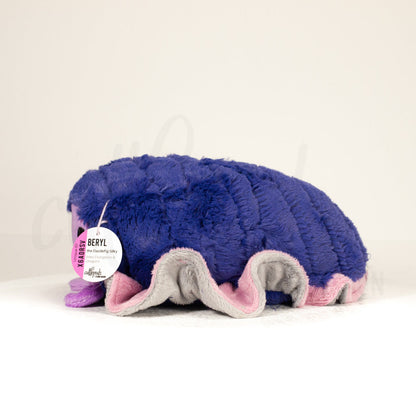 Side profile view of a cuttlepod plush toy, showcasing two-tone ruffled fins, and a cuddly, furry body.